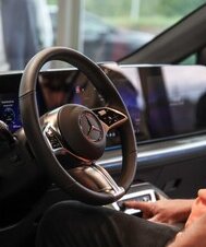 Ein Mann sitzt am Fahrersitz des neuen VLE mit integriertem digitalen Cockpit-Display.
