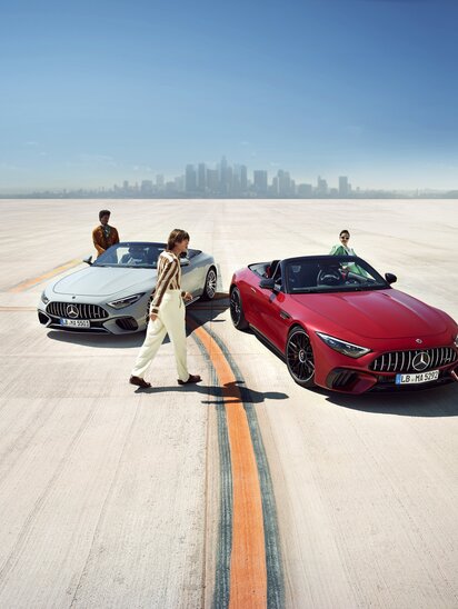 Zwei Mercedes-AMG SL Roadster mit Personen davor auf einer freien Fläche. | © Mercedes-Benz AG