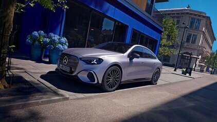 Mercedes-Benz Auto parkt auf einer städtischen Straße vor einem blauen Gebäude, umgeben von Pflanzen. | © Mercedes-Benz AG